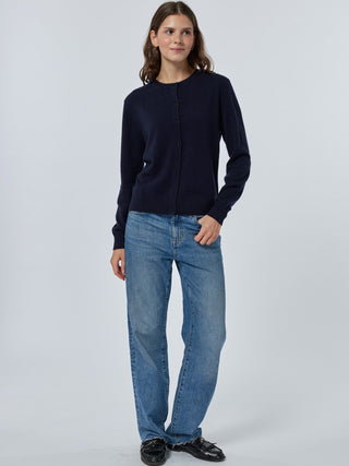 Person wearing a navy sweater and blue jeans on a white background Navy
