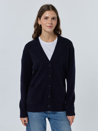Woman wearing a cardigan over a white shirt with a plain background - Navy