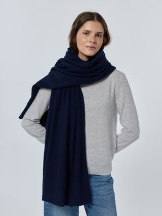 Woman wearing a navy scarf and gray sweater on a white background Navy